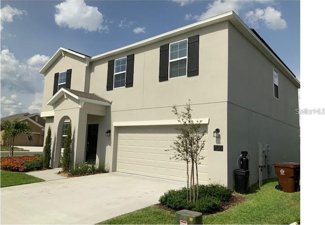 view of front of house featuring stucco siding, driveway, and an attached garage