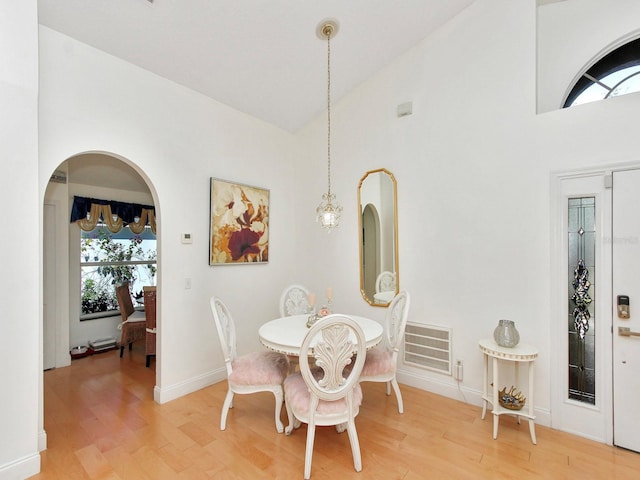 dining space with plenty of natural light, visible vents, and light wood finished floors