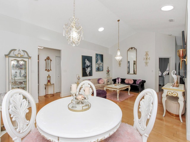 dining room featuring visible vents, recessed lighting, vaulted ceiling, a notable chandelier, and light wood-type flooring