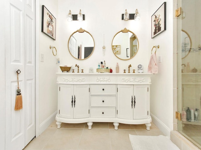 bathroom featuring double vanity, baseboards, a shower stall, and tile patterned flooring