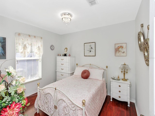 bedroom featuring dark wood-style floors, visible vents, and baseboards