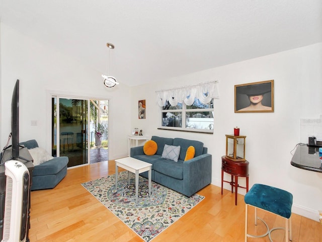 living room featuring vaulted ceiling and wood finished floors