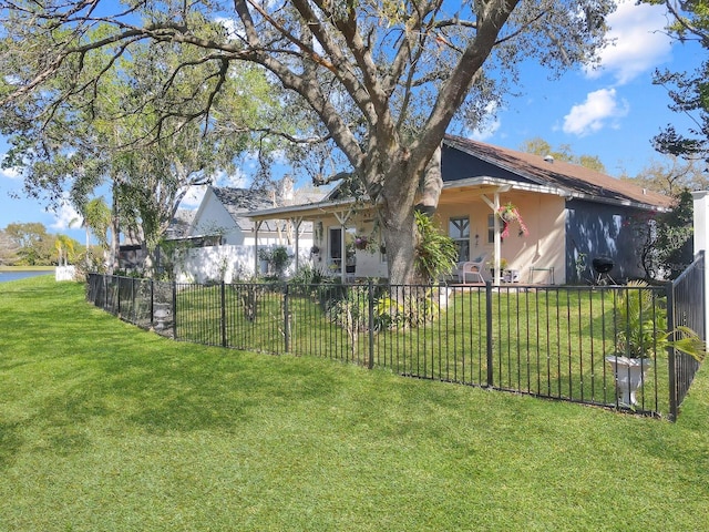 exterior space featuring stucco siding, a lawn, and fence