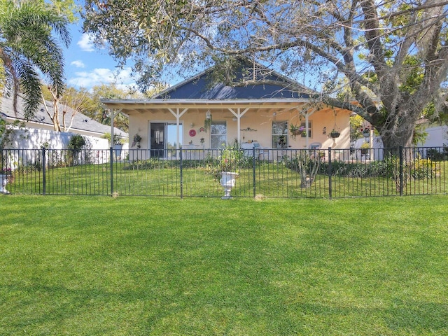 view of front of house with a fenced front yard, stucco siding, and a front lawn