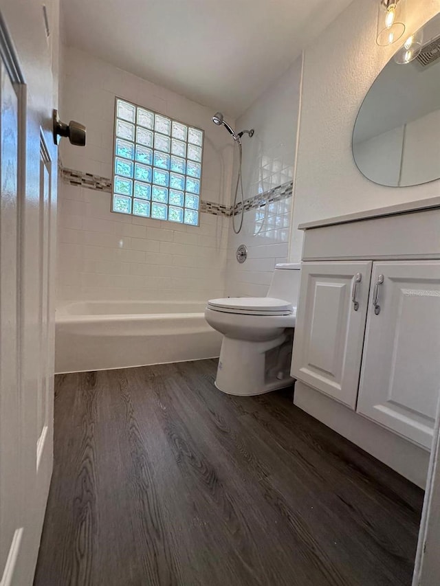 full bath featuring vanity, shower / bathing tub combination, toilet, and wood finished floors