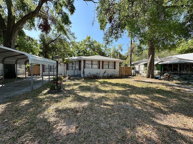 view of front of house featuring a carport and fence