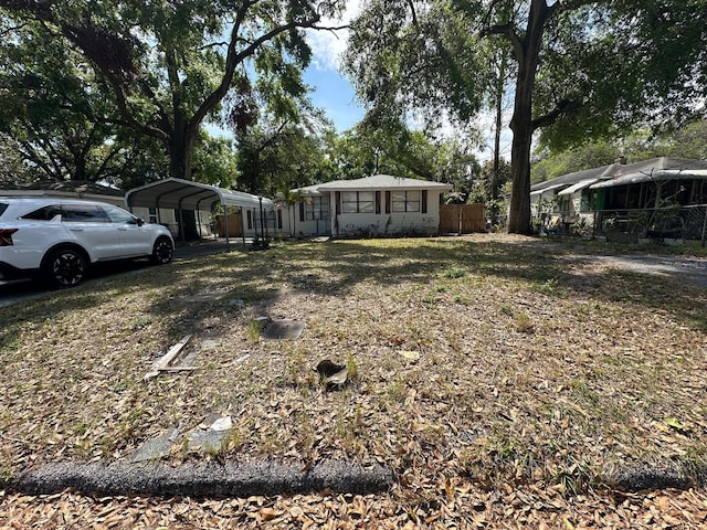 view of yard featuring a detached carport and fence