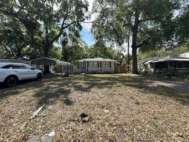 view of yard with a carport and fence