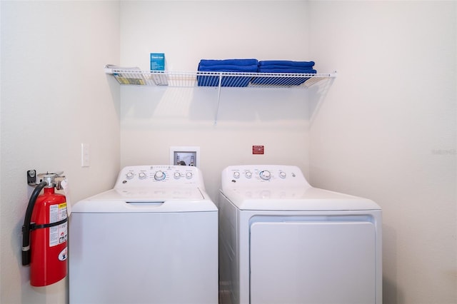 washroom featuring laundry area and washer and clothes dryer