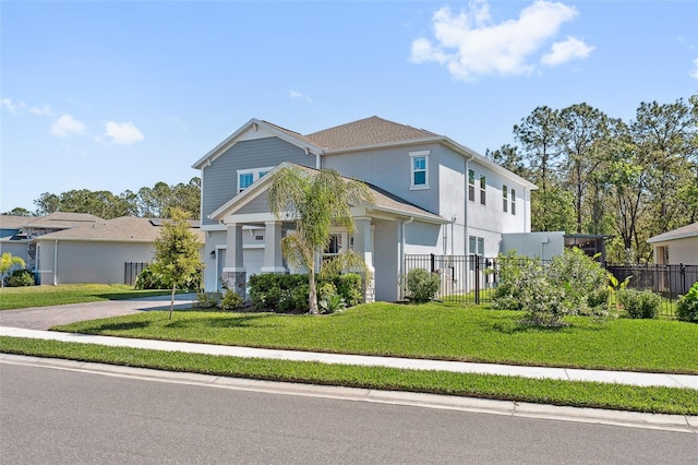 view of front of house featuring decorative driveway, a front lawn, stucco siding, and fence