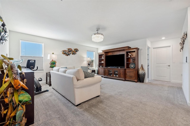 carpeted living area featuring recessed lighting and baseboards