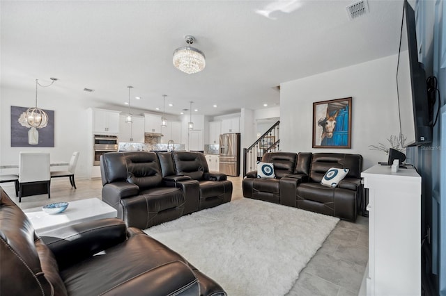 living area with recessed lighting, visible vents, a chandelier, and stairway