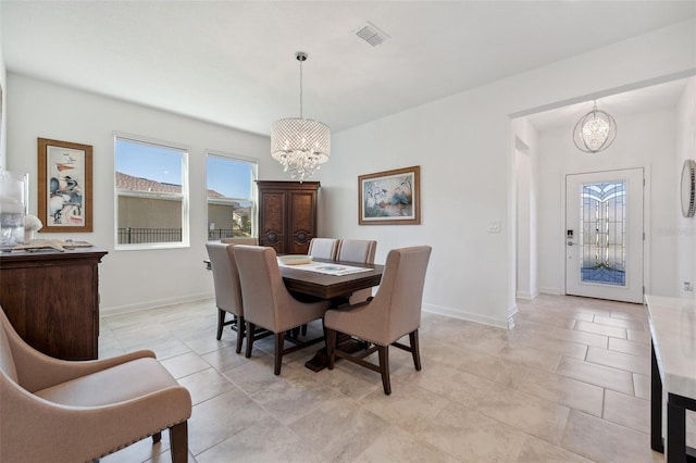 dining area with a notable chandelier, baseboards, and visible vents