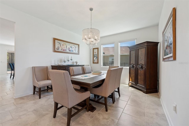 dining room with baseboards and a chandelier