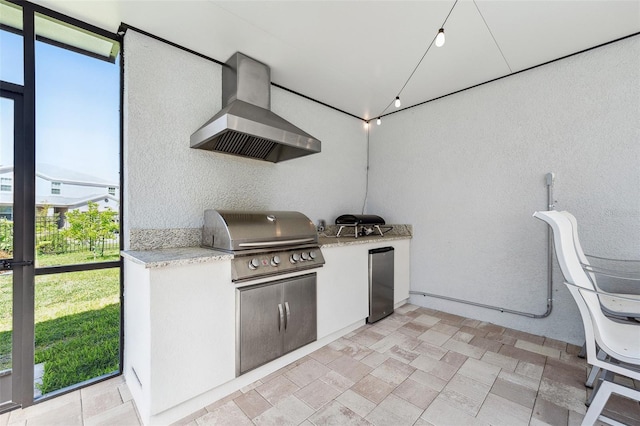 view of patio featuring a grill, exterior kitchen, and fence