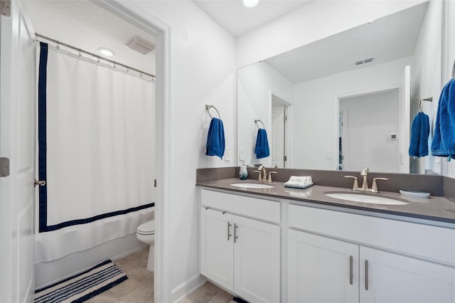 full bath with double vanity, visible vents, and a sink