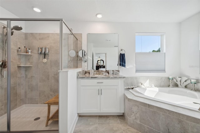 bathroom with a bath, a shower stall, and vanity