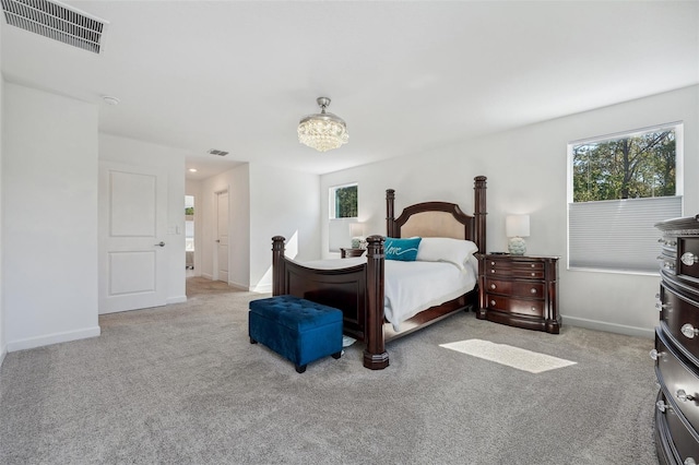 carpeted bedroom featuring visible vents, multiple windows, and baseboards