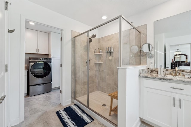 full bathroom featuring recessed lighting, washer / dryer, a stall shower, and vanity