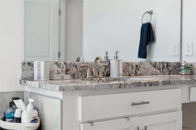 bathroom featuring vanity and tasteful backsplash