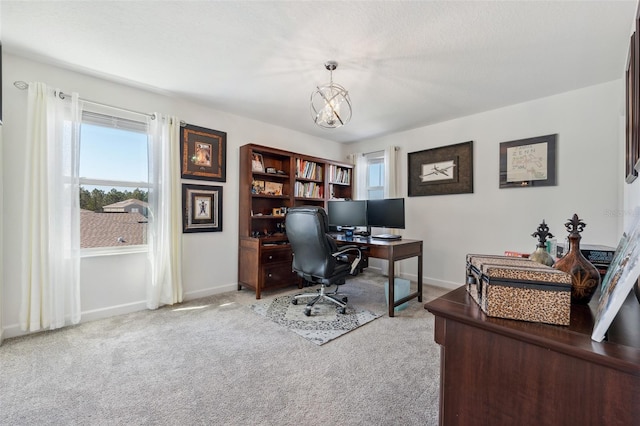 office with baseboards, an inviting chandelier, and carpet floors