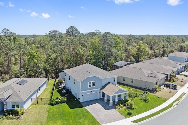 birds eye view of property with a wooded view