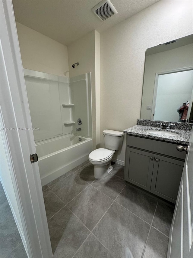 full bath featuring tile patterned floors, visible vents, toilet, bathtub / shower combination, and vanity