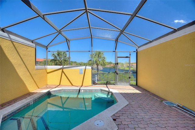 view of swimming pool with glass enclosure, a pool, and a patio area