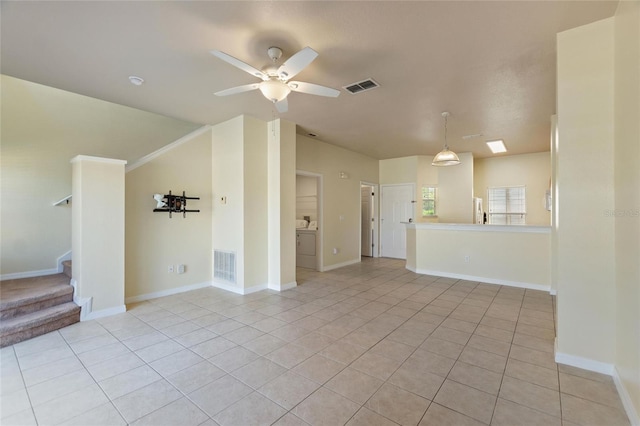 unfurnished living room featuring stairs, light tile patterned flooring, a ceiling fan, and visible vents