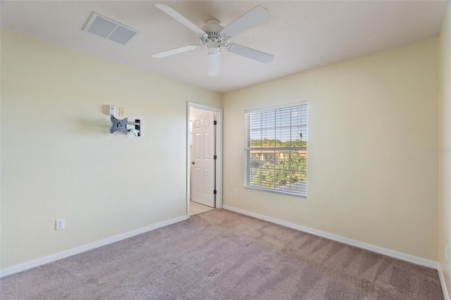 unfurnished room featuring visible vents, baseboards, carpet, and ceiling fan