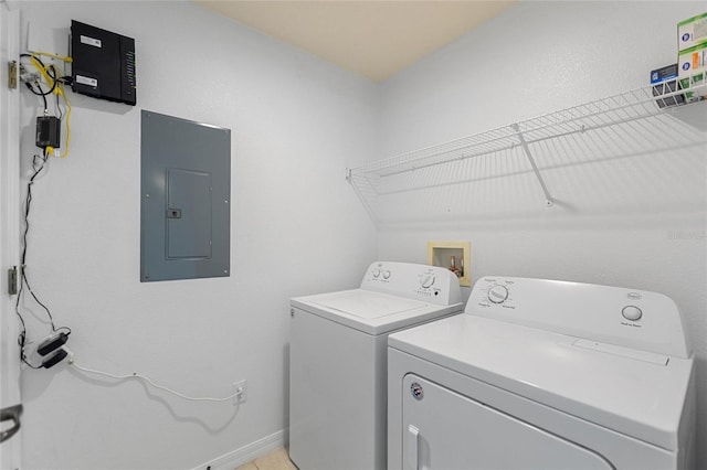 clothes washing area with laundry area, electric panel, baseboards, and independent washer and dryer