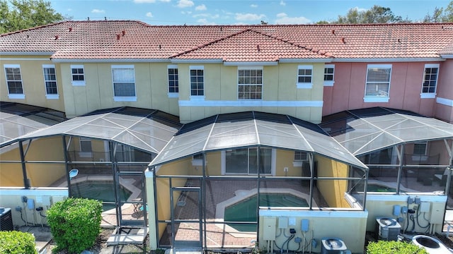 view of property featuring central AC unit and an outdoor pool