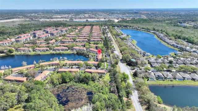 drone / aerial view featuring a residential view and a water view