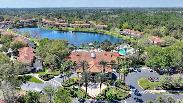 aerial view featuring a forest view and a water view