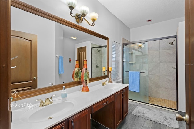 2102 Congress Ln, Saint Cloud, FL 34769 - full bathroom with double vanity, a shower stall, and wood finished floors