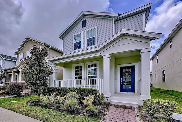 view of front of property with covered porch and stucco siding