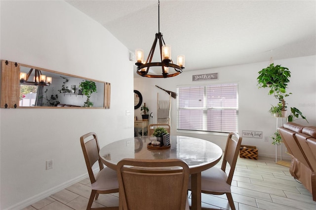 dining area featuring an inviting chandelier, baseboards, and lofted ceiling