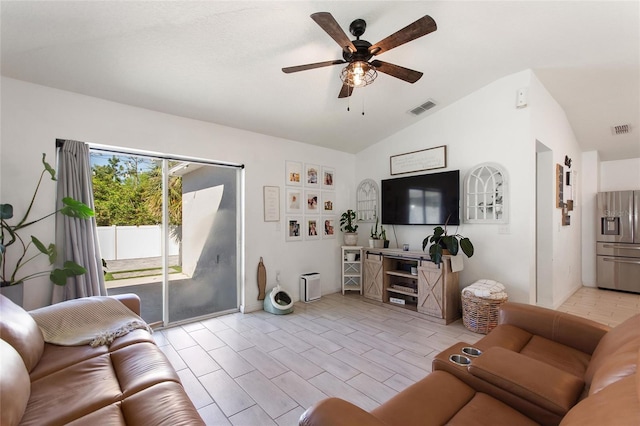 living room featuring visible vents, a ceiling fan, and vaulted ceiling