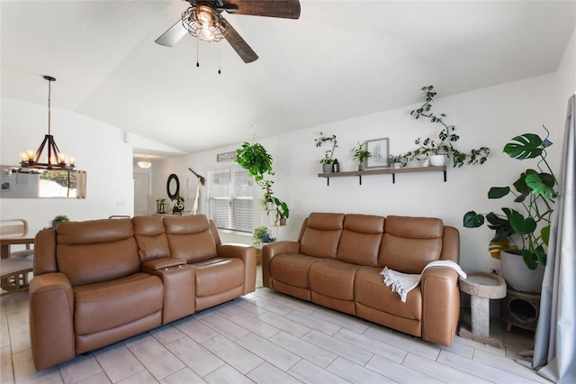 living area with vaulted ceiling and ceiling fan with notable chandelier