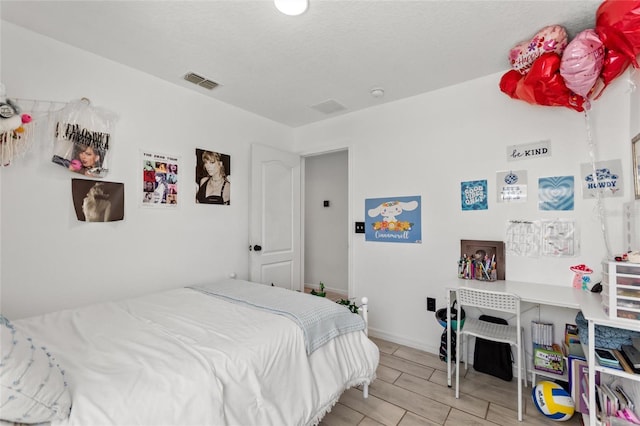 bedroom featuring visible vents and baseboards