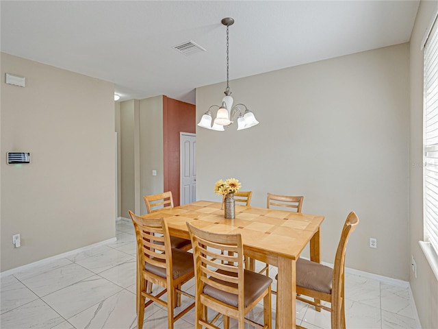 dining space featuring a chandelier, visible vents, marble finish floor, and baseboards