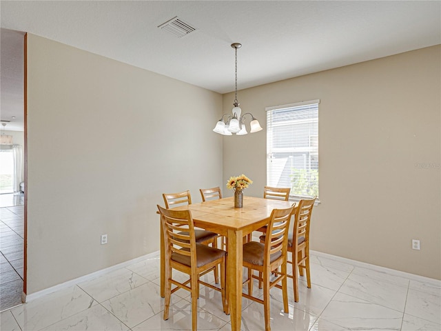 dining space featuring visible vents, marble finish floor, baseboards, and an inviting chandelier