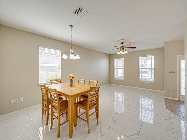 dining area with visible vents, marble finish floor, ceiling fan with notable chandelier, and baseboards