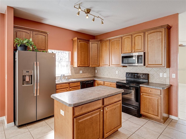 kitchen with black appliances, light tile patterned floors, tasteful backsplash, and a sink