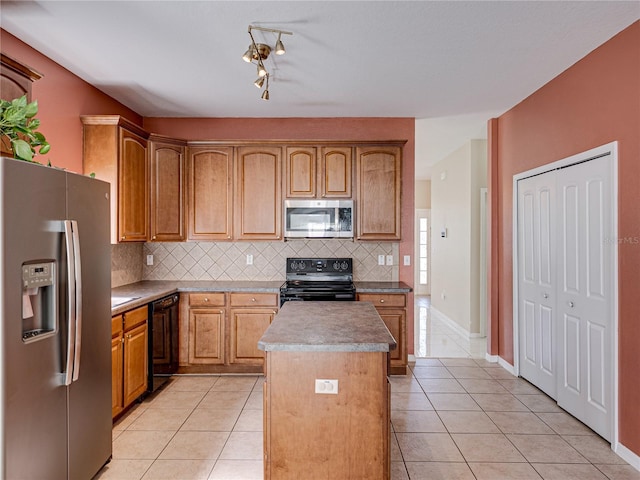 kitchen with decorative backsplash, black appliances, light tile patterned floors, and a kitchen island