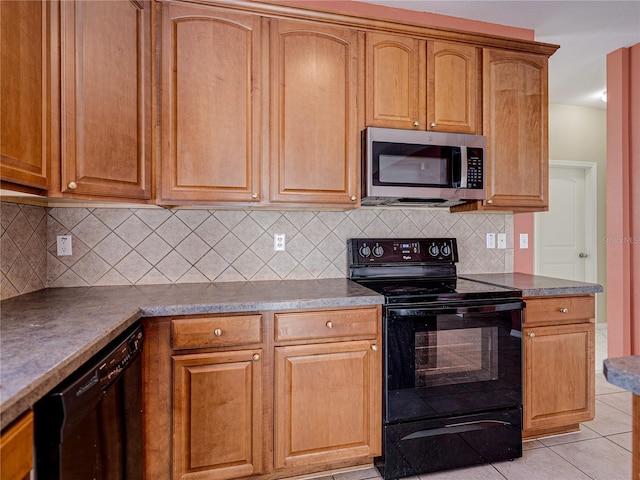 kitchen with black appliances, light tile patterned floors, brown cabinets, and backsplash