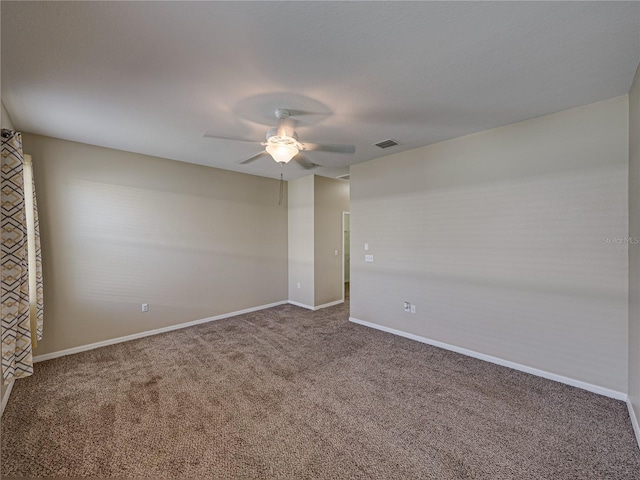 carpeted empty room featuring visible vents, baseboards, and ceiling fan