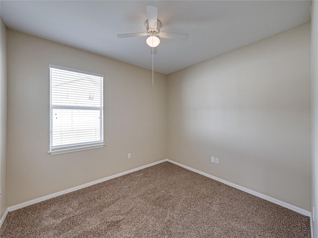 carpeted empty room with baseboards and ceiling fan