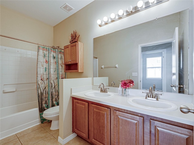 bathroom with tile patterned floors, visible vents, toilet, and a sink