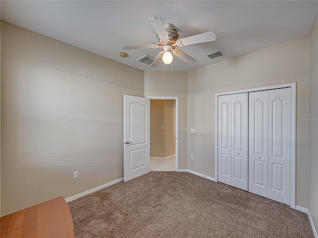 unfurnished bedroom with carpet, visible vents, a closet, and baseboards